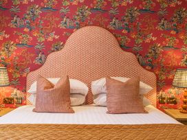A bedroom with a patterned headboard and pillows at Leathes Head Country House in Borrowdale near Keswick