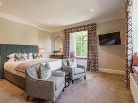 A bedroom with a bed and chairs at Leathes Head Country House Borrowdale near Keswick