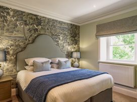 A bedroom with a bed and window at Leathes Head Country House in Borrowdale near Keswick