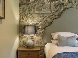 A bedroom with a bed and lamp at Leathes Head Country House Borrowdale near Keswick