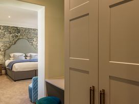 A bedroom with a bed and wardrobe at Leathes Head Country House in Borrowdale near Keswick