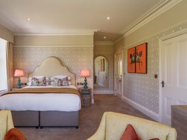 A bedroom with a bed, lamps, and wall art at Leathes Head Country House Borrowdale near Keswick