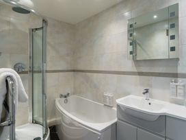 A bathroom with a shower, bathtub, and sink at Leathes Head Country House Borrowdale near Keswick