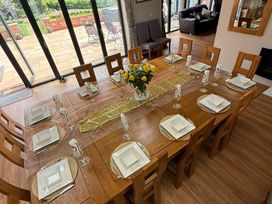 A dining room with a table set for a meal at Crossett Grange in Driffield