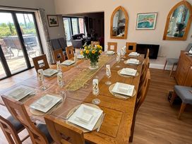 A dining room with a table set for a meal at Crossett Grange in Driffield