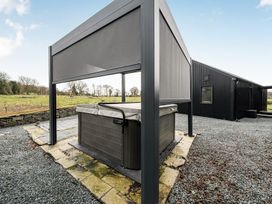 An outdoor area with a hot tub and canopy at Grove Cottage in Kington