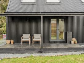An outdoor area with chairs and a door at Grove Cottage Kington