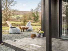 An outdoor area with bean bags and a fire pit at Grove Cottage Kington