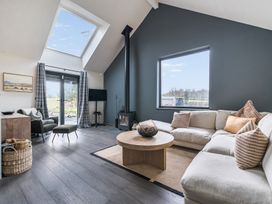 A living room with a sofa and coffee table at Grove Cottage in Kington