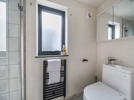 A bathroom with a shower and toilet at Grove Cottage in Kington