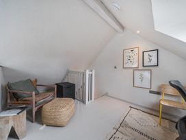 A study with a sofa and artwork on the walls at Grove Cottage in Kington