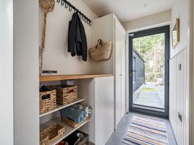 An entryway with a shelf and coat rack at Grove Cottage Kington