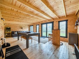 A snug with a table and sofa at Grove Cottage in Kington