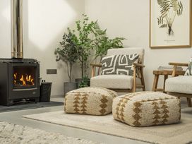 A living room with a fireplace and armchairs at Grove Cottage in Gladestry