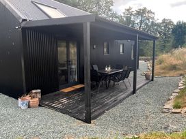 An outdoor area with a table and chairs at Grove Cottage in Gladestry