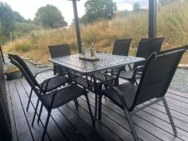A dining area with a table and chairs at Grove Cottage in Gladestry