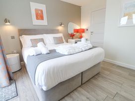 A bedroom with a bed and bedside table with a lamp at Hepworth in Portreath