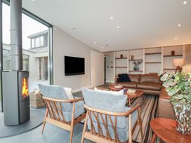 A living room with a fireplace and seating area at Harberton
