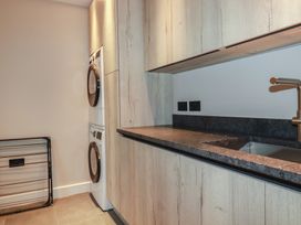 A laundry room with a washer and dryer at Harberton