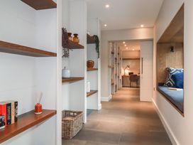 A hallway with shelves and a desk at Harberton
