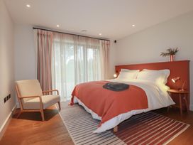 A bedroom with a bed and an armchair at Harberton