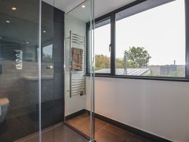 A bathroom with a shower and towel rail at Harberton
