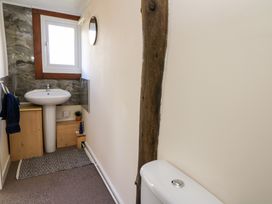 A bathroom with a pedestal sink a toilet a window a mirror and a towel at Shed Your Blues in Brilley near Kington