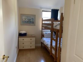 A bedroom with a bunk bed and drawer unit at Millers Cottage Seaville near Wigton