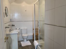 A bathroom with a shower and sink at Millers Cottage near Wigton