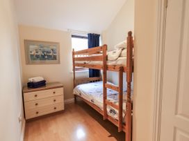 A bedroom with a bunk bed and dresser at Millers Cottage Seaville near Wigton