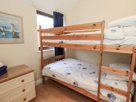 A bedroom with a bunk bed and a dressing table at Millers Cottage near Wigton