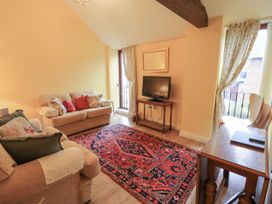 A living room with a sofa and television at The Hayloft near Wigton