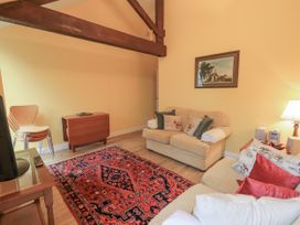 A living room with a sofa and armchair at The Hayloft near Wigton