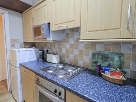 A kitchen with a microwave and fridge at The Hayloft near Wigton