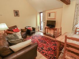 A living room with a tv and sofa at The Hayloft near Wigton