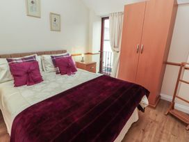 A bedroom with a bed and wardrobe at The Hayloft near Wigton