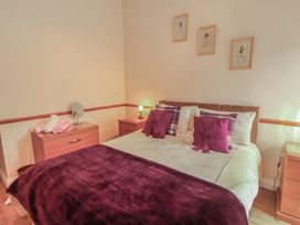 A bedroom with a bed and bedside tables at The Hayloft near Wigton