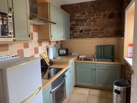 A kitchen with appliances and cabinets at The Coach House near Wigton