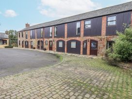 A building with multiple windows and doors at The Coach House near Wigton