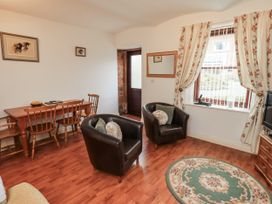 A living room with a dining table and chairs at The Coach House near Wigton