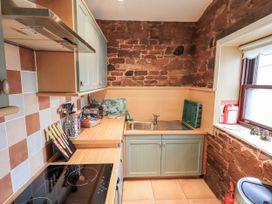 A kitchen with countertop and sink at The Coach House near Wigton