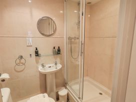 A bathroom with a shower and sink at The Coach House near Wigton