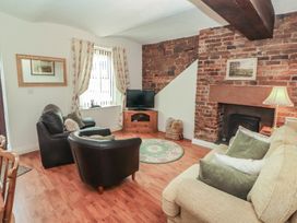 A living room with a sofa and coffee table at The Coach House near Wigton