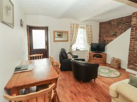A living room with a dining table and chairs at The Coach House near Wigton