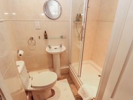 A bathroom with a toilet, sink, and shower at The Coach House near Wigton