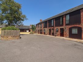 A view of houses and trees in a parking area at The Coach House near Wigton