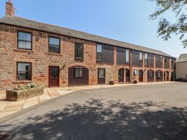 A brick building with windows and doors at The Coach House near Wigton