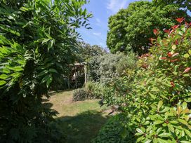 A garden with trees and bushes at Magnolia View Goodleigh near Barnstaple