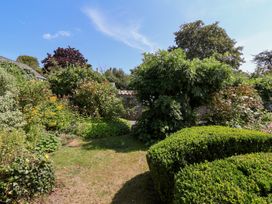A garden with bushes and a pathway at Magnolia View Goodleigh near Barnstaple