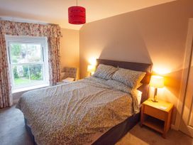 A bedroom with a bed and window at 5 Bed Cottage Mumbles